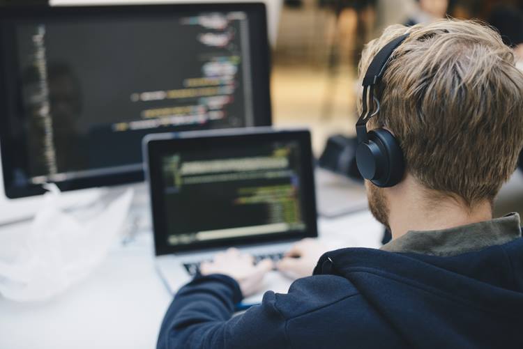Businessman programming on laptop at creative office